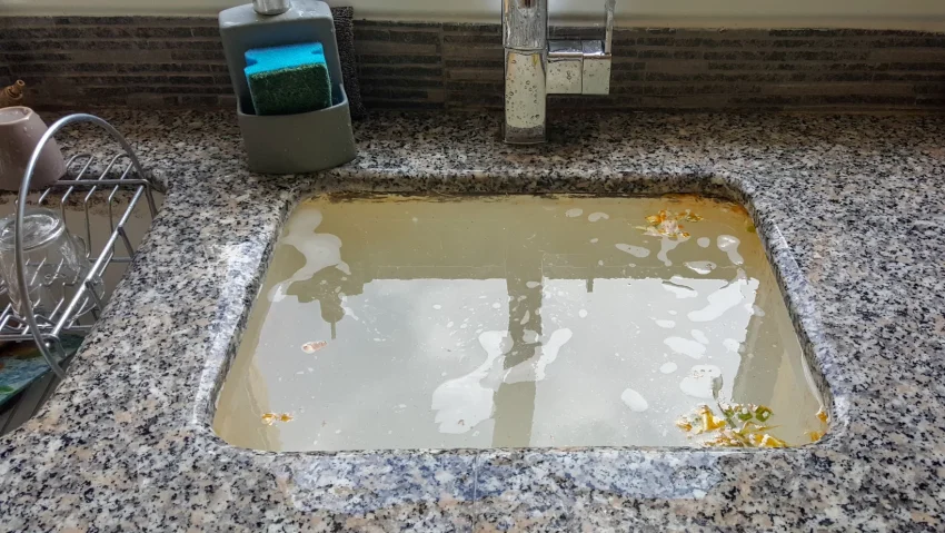 Water pooling in a Portsmouth kitchen sink caused by slow draining and hidden pipe blockages.